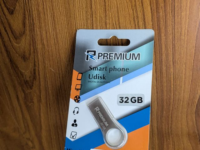 A 32GB USB flash drive in retail packaging
